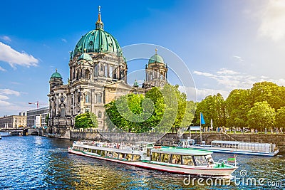 Berlin Cathedral with boat on Spree river at sunset, Germany Stock Photo