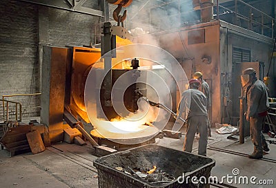 Berlin, Germany - April 18, 2013: Production of metal components in a foundry - group of workers Editorial Stock Photo