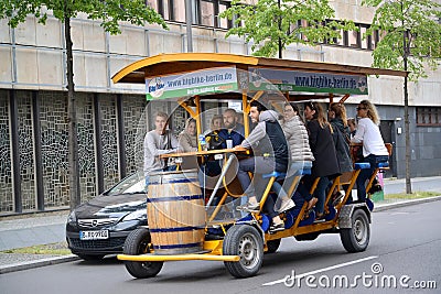 BERLIN, GERMANY. Young people in a beer bike ride down the street Editorial Stock Photo