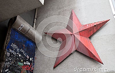 Part of the Berlin wall and red star near Checkpoint Charlie between east and west sectors Editorial Stock Photo