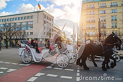 Berlin, Germany - December 02, 2016: White carriage with black horses in Berlin on the street Editorial Stock Photo