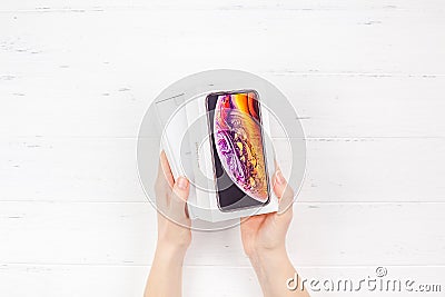 Woman hands with latest Apple iPhone XS box Editorial Stock Photo