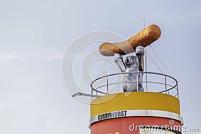 Bear as a symbol of the city Berlin holding big Curry Wurst sausage Editorial Stock Photo