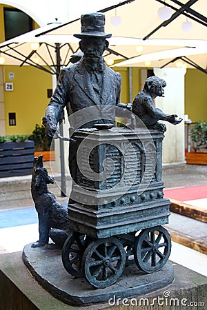 Berlin, Germany - November 9, 2023: Statue of Leierkastenmann, or street organ grinder near Hotel Nikolai Residence in old Editorial Stock Photo
