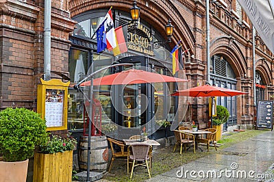 Restaurant in the historic arcades under the railway at the trendy quarter Hackescher Markt in downtown Berlin. Editorial Stock Photo