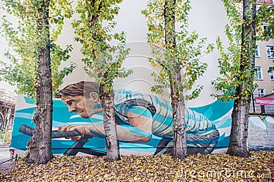 BERLIN, GERMANY - OCTOBER 29, 2012: Wall Painting in Berlin with Guy Riding Bicycle Editorial Stock Photo