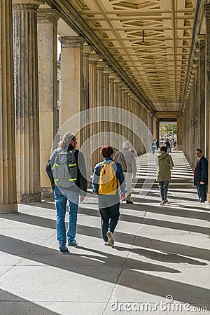 BERLIN, GERMANY - SEPTEMBER 26, 2018: Colorful perspective of people walking under an ancient greek construction that Editorial Stock Photo