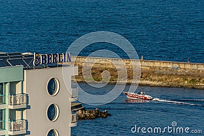 Berlin Golden Beach Hotel, bay, seawall and motorboat in Bulgarian resort Editorial Stock Photo