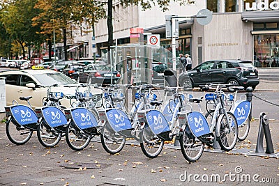 Berlin, October 2, 2017: Bicycle rent. Number of bicycles stand on the bike parking in Berlin against the backdrop of Editorial Stock Photo