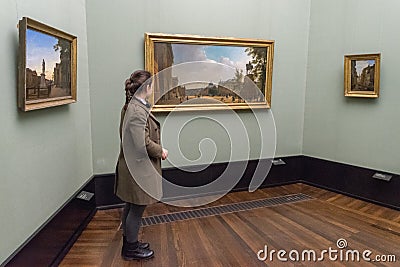 BERLIN - OCTOBER 20, 2016: Girl admiring paintings in famous Alt Editorial Stock Photo