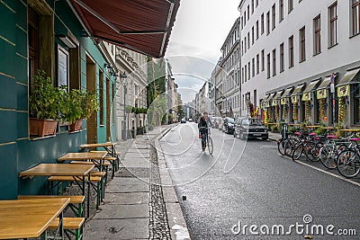 BERLIN - OCTOBER 20, 2016: Girl riding a bicycle on a street in Berlin Editorial Stock Photo