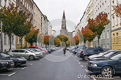 BERLIN - OCTOBER 19, 2016: Man on a bike riding down a street Editorial Stock Photo