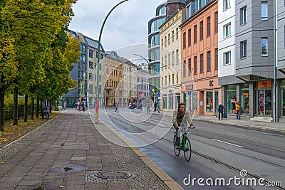 BERLIN - OCTOBER 20, 2016: Man riding a bicycle on a street in Berlin Editorial Stock Photo