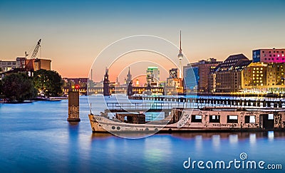 Berlin skyline with old ship wreck in Spree river at dusk, Germany Stock Photo