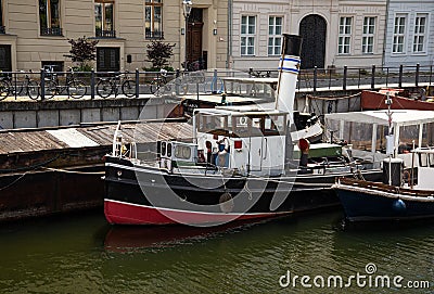 Berlin, Spree river, Germany. Old river ships at the embankment Editorial Stock Photo