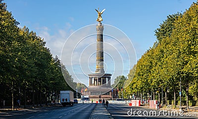 Berlin Victory Column. Golden statue of angel tries to touch the sky. Clouds, trees background Editorial Stock Photo