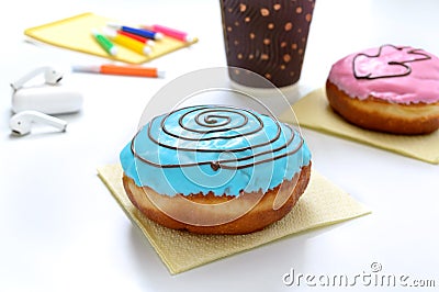 Berliner donuts, coffee, headphones and materials for creativity on a white office desk. Snack dessert at the workplace, lunch Stock Photo