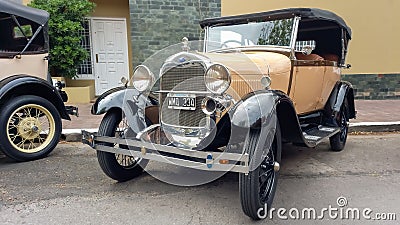 Old cream 1930s Ford Model A double phaeton convertible parked in the street. Classic car show. Editorial Stock Photo