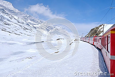 Bernina mountain pass. The famous red train is crossing the white lake. Amazing landscape of the Switzerland land. Famous Editorial Stock Photo