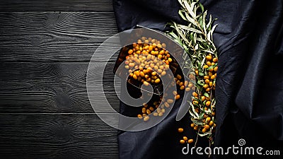 berries and branches of sea buckthorn on a background of black boards Stock Photo
