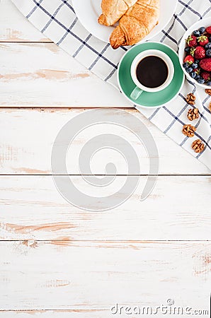 Berries, nuts, croissans and cup of coffee on wooden background Stock Photo