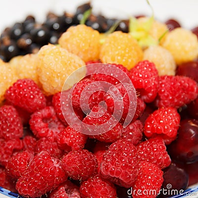 Berries plate, ripe fresh assorted, white and red raspberries, cherries, and currants Stock Photo