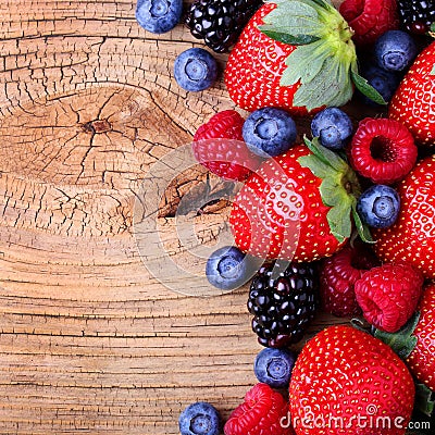 Berries on Wooden Background. Strawberries, Blueberry Stock Photo