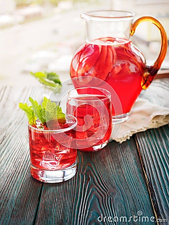 Berry compote decanter glasses with apple slices on wooden rustic background solar. Stock Photo