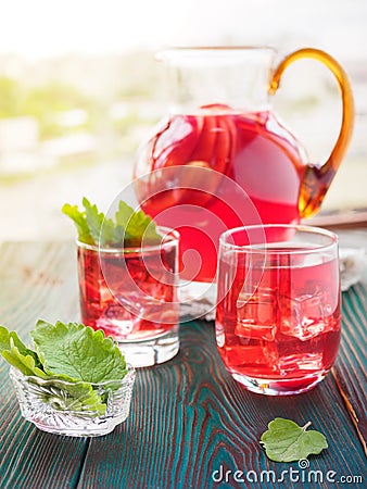 Berry compote decanter glasses with apple slices on wooden rustic background solar. Stock Photo