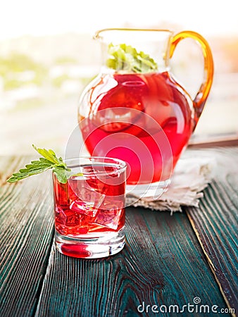 Berry compote decanter glasses with apple slices on wooden rustic background solar. Stock Photo