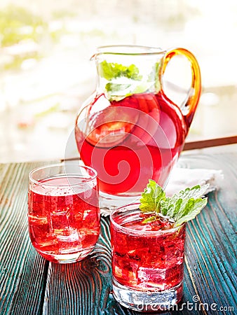 Berry compote decanter glasses with apple slices on wooden rustic background solar. Stock Photo