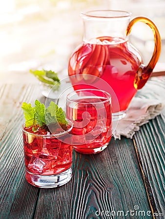 Berry compote decanter glasses with apple slices on wooden rustic background solar. Stock Photo