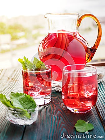 Berry compote decanter glasses with apple slices on wooden rustic background solar. Stock Photo