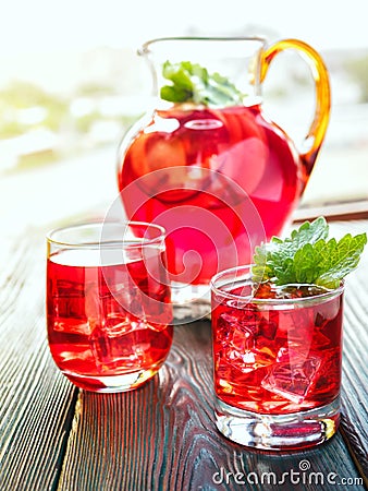 Berry compote decanter glasses with apple slices on wooden rustic background solar. Stock Photo