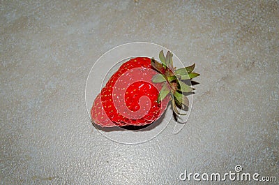 Berry of a red garden strawberry on a light background. Photo of fruit on a white background. Large red strawberry Stock Photo