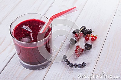 Berry smoothie on the white wooden background. Happy face with berries for kids Stock Photo