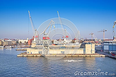 Berth cargo port with cranes on the background of the morning sky Stock Photo