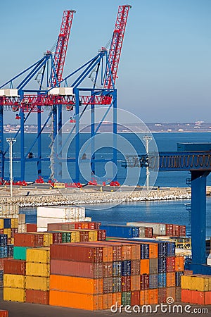 Berthing container heavy cranes for loading multi-colored containers. Stock Photo