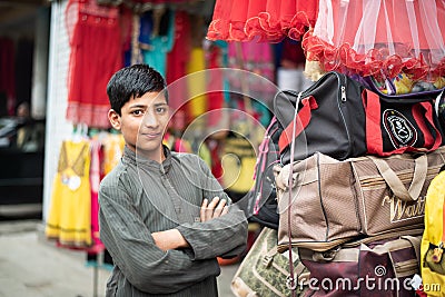 BESHAM, PAKISTAN - April 15, 2018: Unidentified smiling young boy standing by the street market Editorial Stock Photo