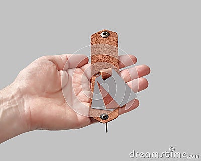 Bespoke brown leather key holder with printed family portrait in male hand Stock Photo