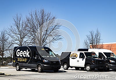 Best Buy retail store exterior geek squad vans parked Editorial Stock Photo