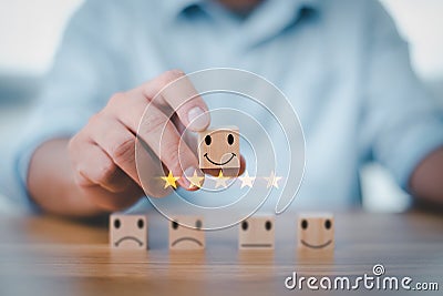 Best excellent business services rating customer experience. Satisfaction survey concept. Hand of a businessman chooses a smiley f Stock Photo