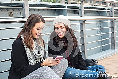 Best friend girls with mobile Stock Photo