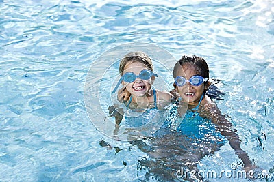 Best friends, girls smiling in swimming pool Stock Photo