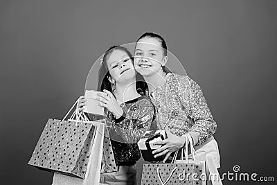 Best friends. Kid fashion. shop assistant has pack. Sales discounts. Sisterhood. Holiday purchase. Small girl best Stock Photo