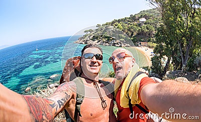 Best friends taking selfie at Giglio Island on adventure travel - Wanderlust lifestyle concept with gay couple enjoying happy fun Stock Photo