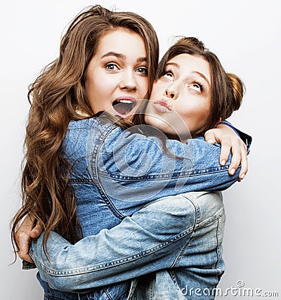 Best friends teenage girls together having fun, posing emotional on white background, besties happy smiling, lifestyle Stock Photo