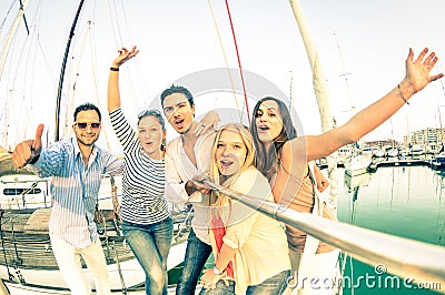 Best friends using selfie stick taking pic on exclusive sailboat Stock Photo