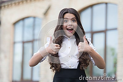 The best of the best. Happy kid show thumbs ups outdoors. Back to school. Education approval. Happy learning. Private Stock Photo