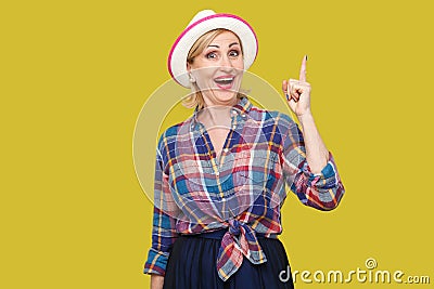 The best idea. Portrait of excited happy modern stylish mature woman in casual style with hat standing, looking at camera with Stock Photo
